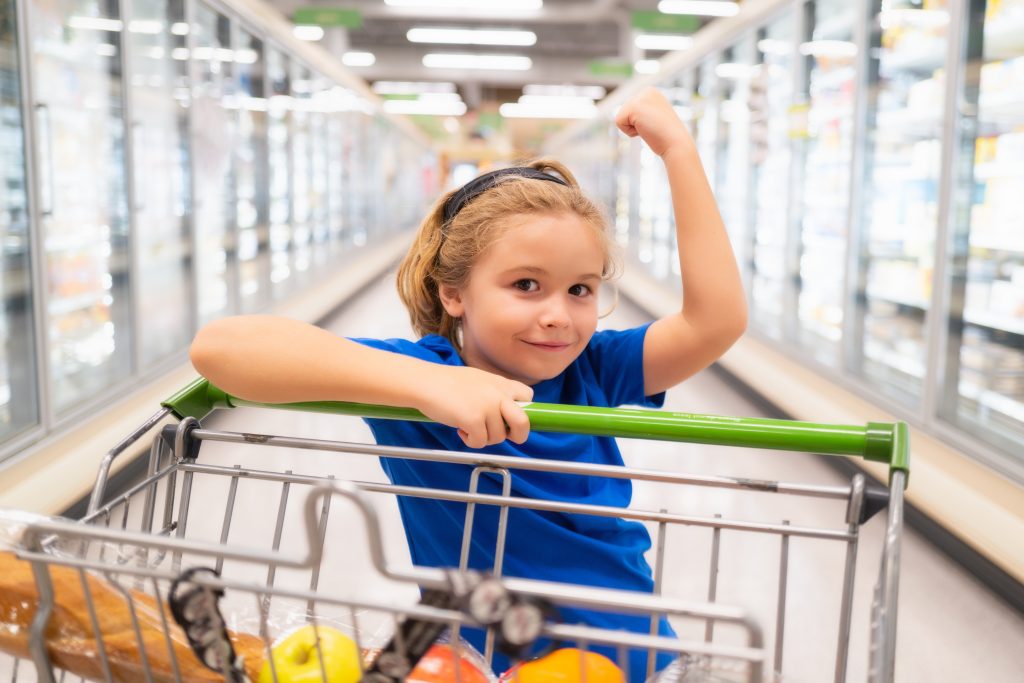 Happy customer in supermarket aisle with clear refrigerated cooler doors, dry floors, and a comfortable temperature. Keep grocery stores, big box stores, supermarkets, retail outlets fee of condensation with Air-Row destratification fans. 
